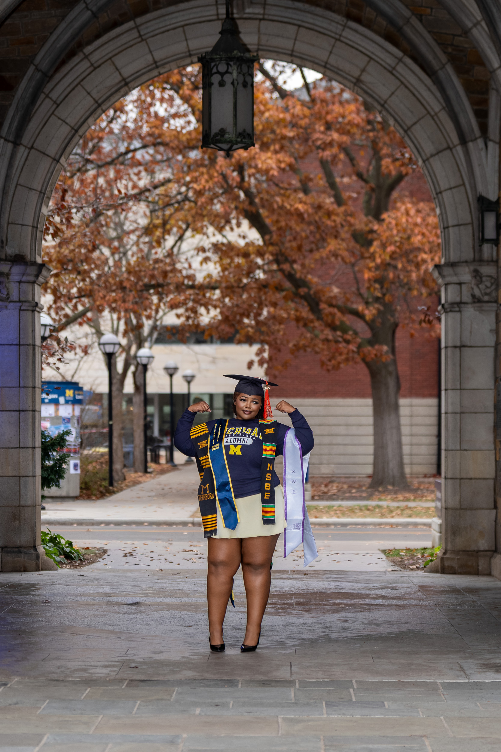 Graduation portrait framed by campus architecture